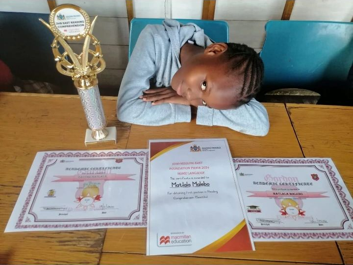 Motlala Malebo with trophy and certificates for 1st place in JHB East Reading Comprehension 2024